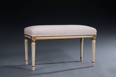 an upholstered foot stool with a beige upholstered seat