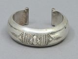 silver cuff bracelet with a fish motif on the side