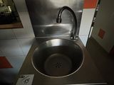 a stainless steel sink in a public restroom