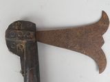 an old rusty axe with a wooden handle on a white surface