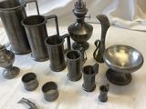 many different types of pewware sitting on a table