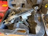 a gun in a case with a wrench in it