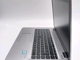 a silver laptop computer sitting on top of a white table