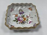 a close up of a small plate with flowers on it