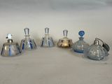 four small glass bottles with blue tops and silver tops