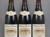 three bottles of wine are lined up on a table