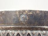 a silver vase that has a face on it