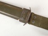 a knife that is laying on top of a belt