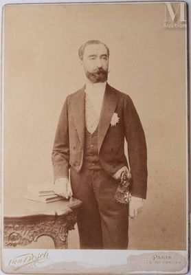 an old photo of a man in a suit and bow tie