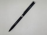 a black pen sitting on top of a white table