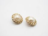 a pair of pearl and gold earrings on a white background