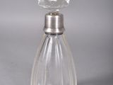 a clear glass bottle with a silver top