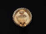 a close up of a gold ring with a picture of a train on it