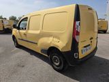 the yellow van is parked in a parking lot with other vans in the background