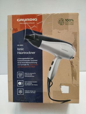 packaging of a hair dryer sitting on top of a cardboard box