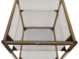 a close up of a glass and brass coffee table on a white background