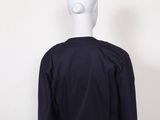 the back view of a mannequin head wearing a black shirt