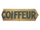 a wooden sign that says coiffeur on it