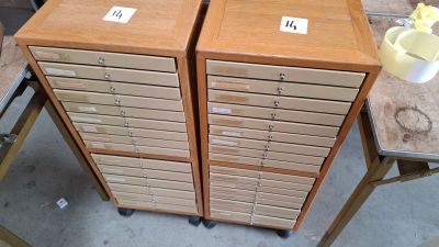 two wooden filing cabinets sitting on top of a table