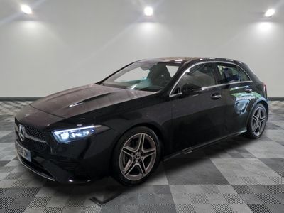 a black mercedes cla parked in a garage with a checkered floor