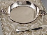 a silver plate with a spoon and fork in it