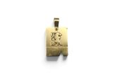 a close up of a gold pendant with a dog on it