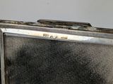 a small metal box with a mirror inside of it