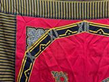 a close up of a red and black quilt with a design on it