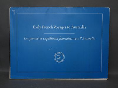 a blue book sitting on top of a table next to a black background