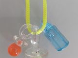 a necklace with a bottle of water and a bottle of soap