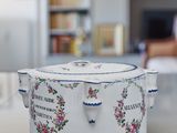 a white table with a blue and white bowl on it