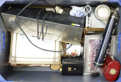 a blue box filled with assorted items and a clock