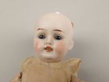 a small doll that is sitting on a table