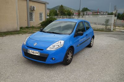 a blue car that is parked in a parking lot