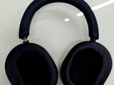 a pair of black headphones sitting on a table