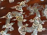 a wooden table with a dragon design on the top of it