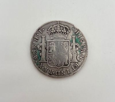 une pièce d'argent sur laquelle figurent des armoiries