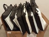 many bags of luggage sitting on top of a cardboard box