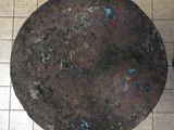 a large metal object on a tiled floor next to a black object