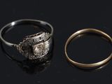 two rings are sitting next to each other on a black surface