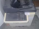 a printer sitting on top of a desk next to a wall