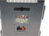 a black control box with a red button on it