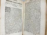 an open book with writing on it sitting on top of a table