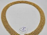 a gold chain bracelet with two charms on it