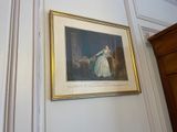 a picture of a woman in a white dress hanging on a wall
