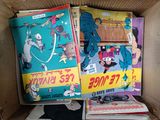 a cardboard box filled with comics and other comics