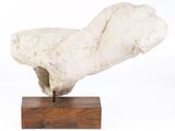 sculpture of a white rock on a wooden base on a white background