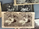 several old black and white photos of people and animals on a table