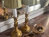 two lamps that are on a table with a mirror in the background