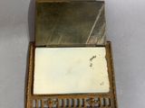 an old wooden box with a mirror in it sitting on a table